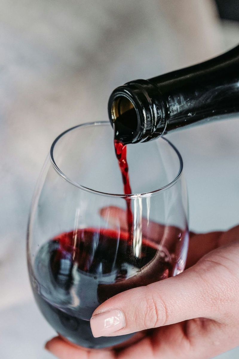 Close-up of red wine being poured into a glass.