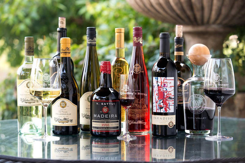 A variety of V. Sattui Winery wines displayed on a glass table.