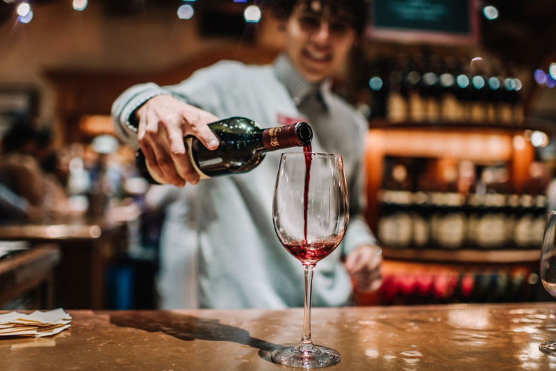 wine expert pouring wine in glass